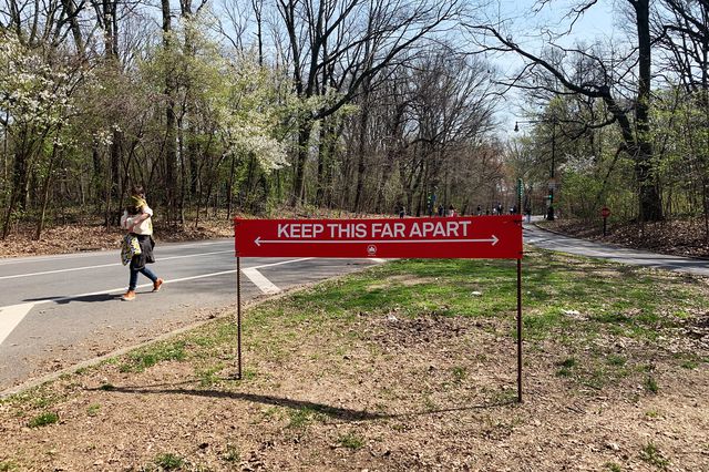 A sign in Prospect Park tells people to stand six feet apart, with marks showing how far six feet is
